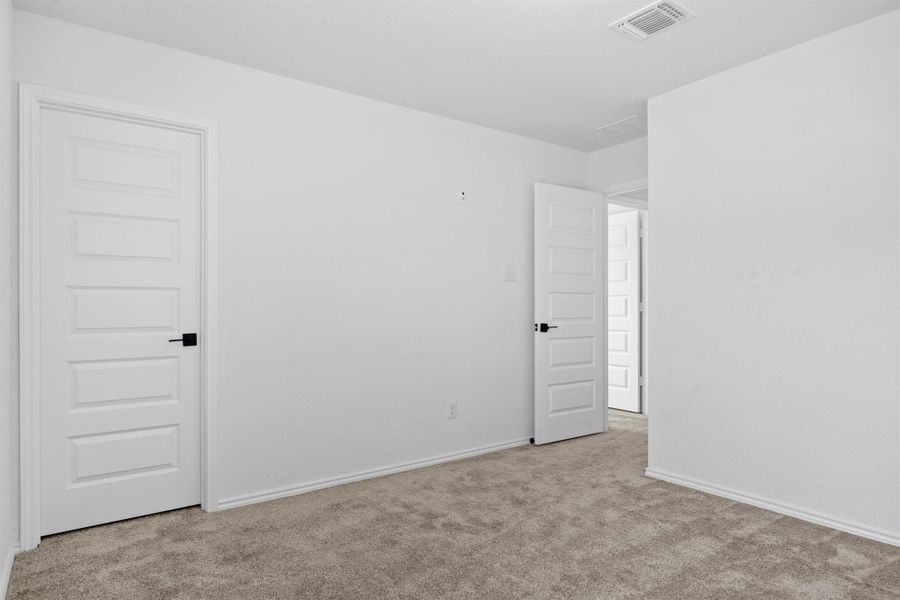 Carpeted empty room with baseboards