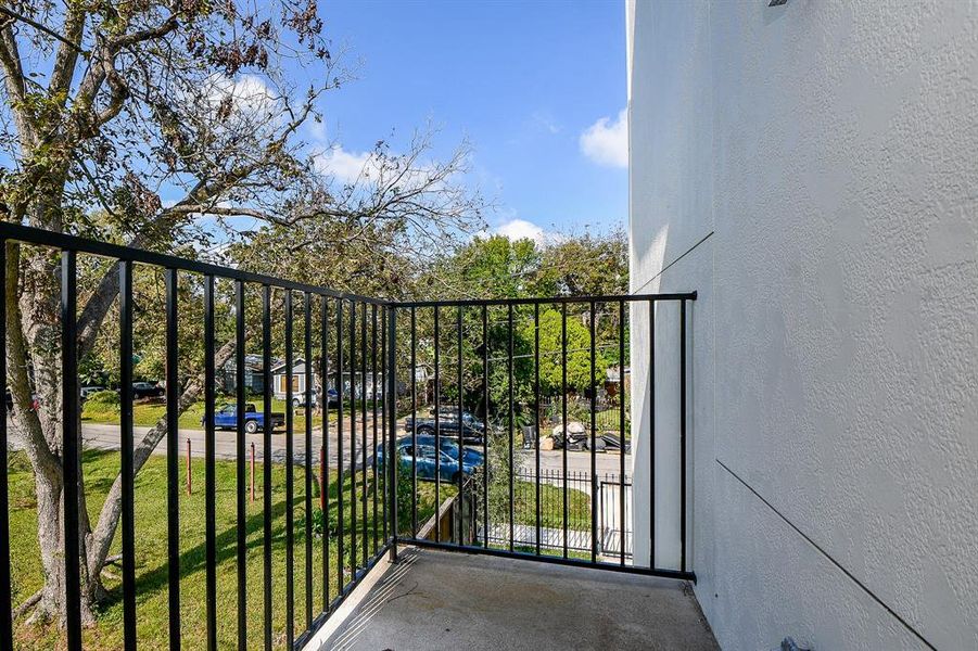 Step into luxury on your private balcony! Adorned with elegant ceramic tile flooring and a timeless wrought iron railing, this outdoor oasis provides a perfect blend of style and durability.