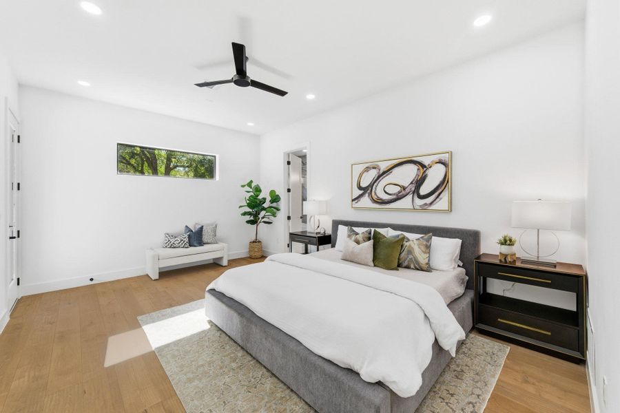 Primary bedroom featuring light wood-type flooring, recessed lighting, and ceiling fan, natural light plus located downstairs with access to private backyard Primary bedroom featuring light wood-type flooring, recessed lighting, and ceiling fan, natural light plus located downstairs with access to private backyard