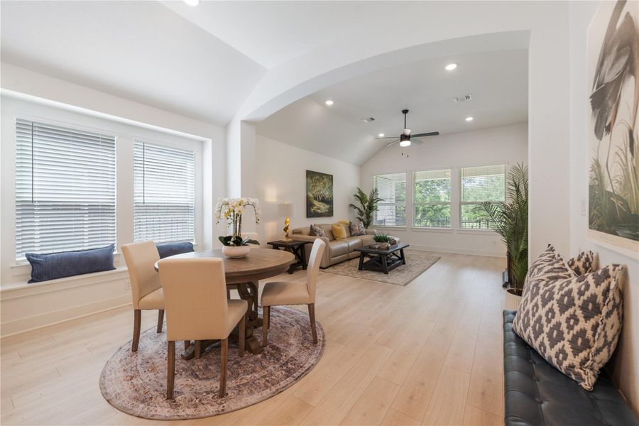 An inviting open-concept living and dining area with light wood flooring awaits. An inviting open-concept living and dining area with light wood flooring awaits.