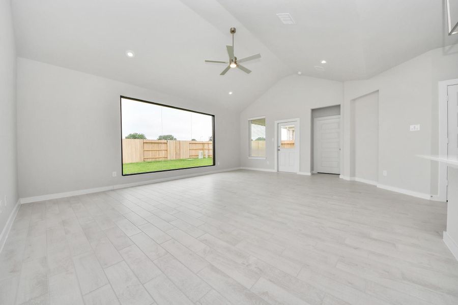 Gather the family and guests together in your lovely living room! Featuring soaring high ceilings, recessed lighting, ceiling fan, custom paint, gorgeous floors, and large windows that provide plenty of natural lighting throughout the day. Sample photo of completed home with similar floor plan. Actual colors and selections may vary. Gather the family and guests together in your lovely living room! Featuring soaring high ceilings, recessed lighting, ceiling fan, custom paint, gorgeous floors, and large windows that provide plenty of natural lighting throughout the day. Sample photo of completed home with similar floor plan. Actual colors and selections may vary.
