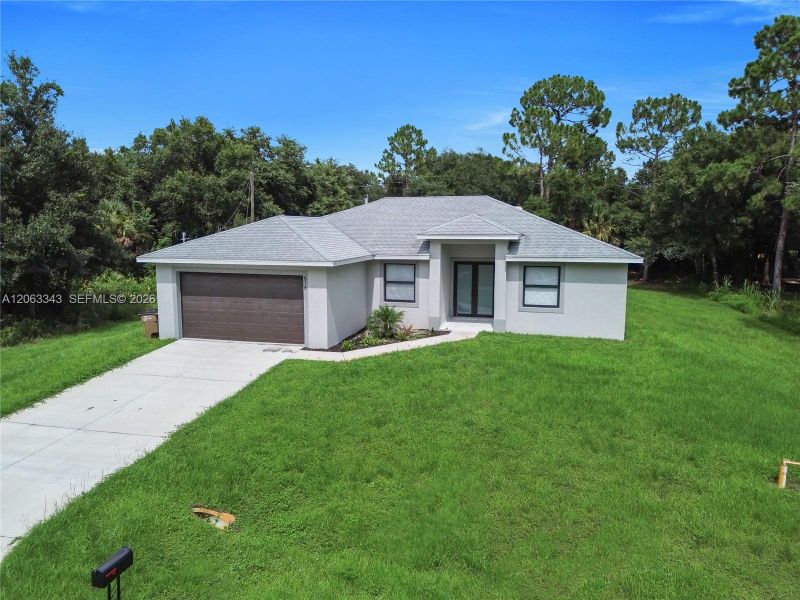 Front exterior of a new home in , Lehigh Acres, FL, highlighting curb appeal (Image 21). Front exterior of a new home in , Lehigh Acres, FL, highlighting curb appeal (Image 21).