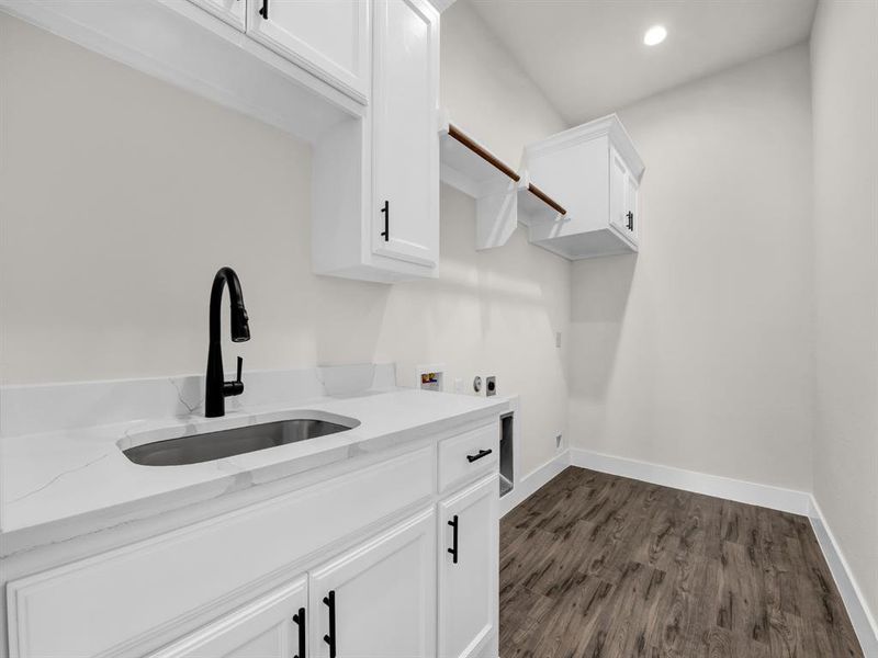 Laundry room featuring dark wood-type flooring, hookup for a washing machine, recessed lighting, electric dryer hookup, and cabinet space