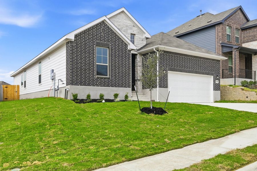 Front exterior of a new home in Seven Oaks Townhomes, Tomball, TX, highlighting curb appeal (Image 2). Front exterior of a new home in Seven Oaks Townhomes, Tomball, TX, highlighting curb appeal (Image 2).