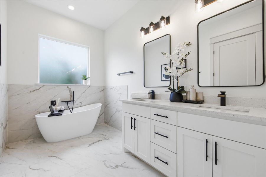 Marble accents and a freestanding soaking tub create a spa-like retreat in this pristine primary bathroom. Marble accents and a freestanding soaking tub create a spa-like retreat in this pristine primary bathroom.