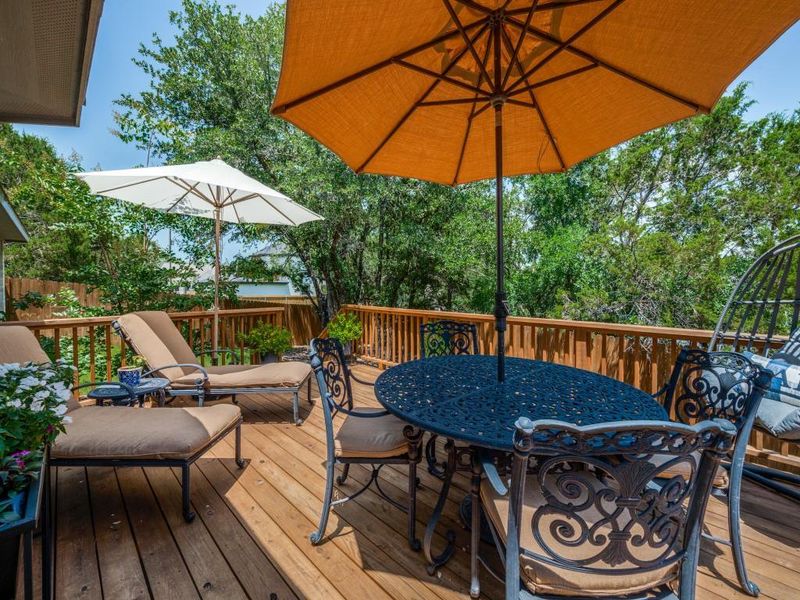Wooden terrace featuring outdoor dining area Wooden terrace featuring outdoor dining area