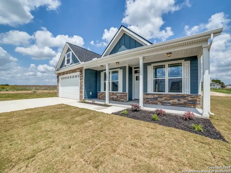 Front exterior of a new home in Las Palomas Country Club Estates, La Vernia, TX, highlighting curb appeal (Image 1). Front exterior of a new home in Las Palomas Country Club Estates, La Vernia, TX, highlighting curb appeal (Image 1).