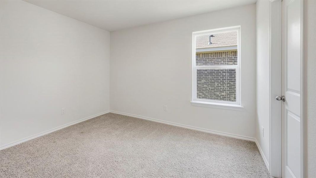 Unfurnished room with light carpet and baseboards