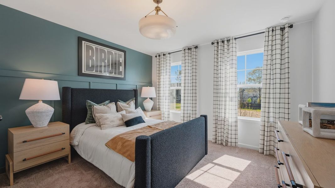 Comfortable secondary bedroom with large windows in new construction townhome at Langley Overlook in Loganville, GA. Comfortable secondary bedroom with large windows in new construction townhome at Langley Overlook in Loganville, GA.