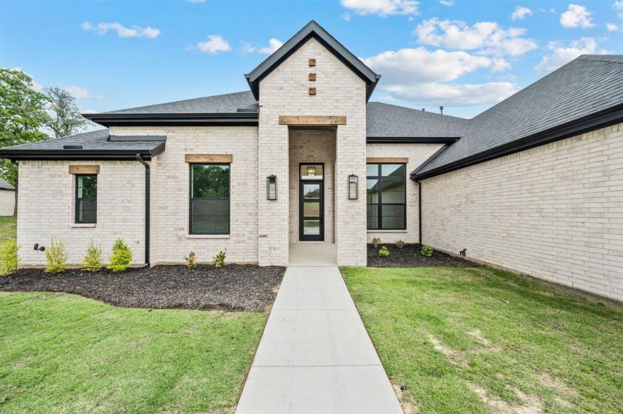 Front exterior of a new home in Highland Oaks, Boyd, TX, highlighting curb appeal (Image 27).