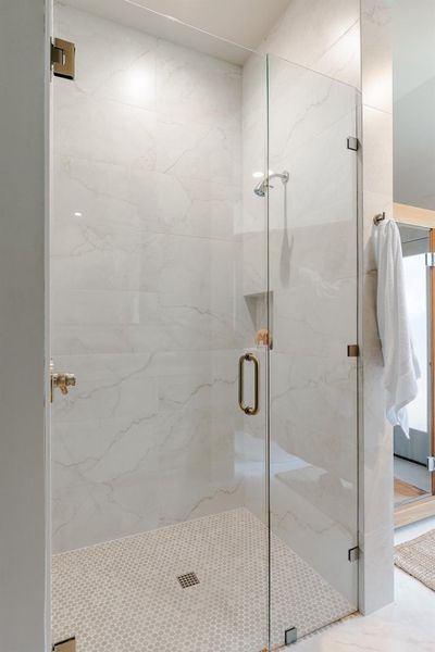 Full bath featuring a marble finish shower