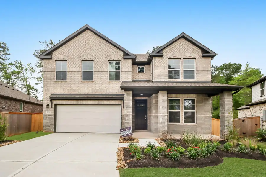 Front exterior of a new home in The Woodlands Hills, Willis, TX, highlighting curb appeal (Image 1).