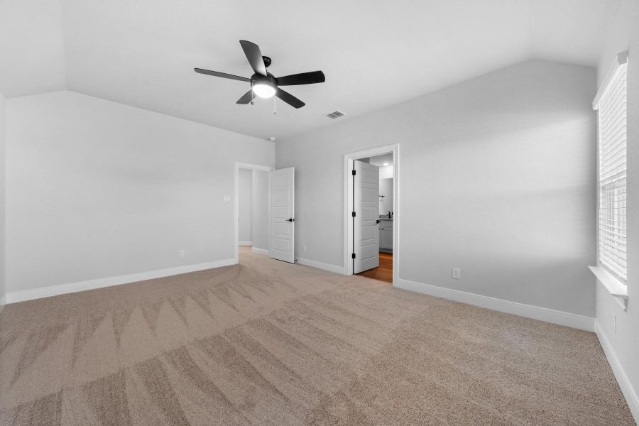 Unfurnished bedroom with lofted ceiling, light colored carpet, and ceiling fan