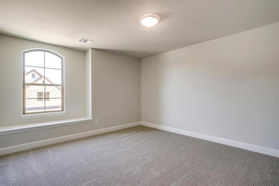 Spare room with baseboards and light colored carpet Spare room with baseboards and light colored carpet