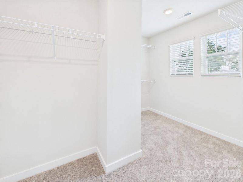 Spacious primary closet Spacious primary closet
