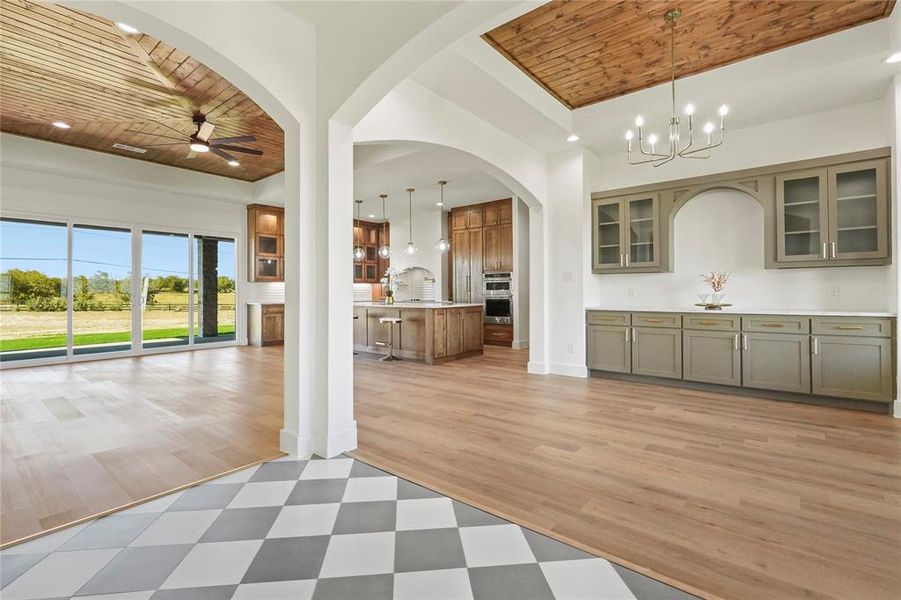 Bar with wooden ceiling, glass insert cabinets, hanging light fixtures, light countertops, and recessed lighting Bar with wooden ceiling, glass insert cabinets, hanging light fixtures, light countertops, and recessed lighting