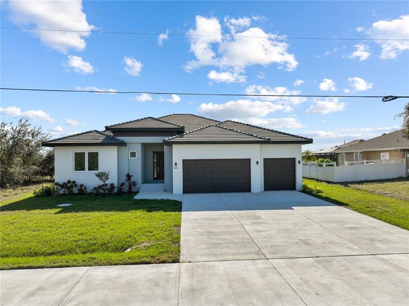 Front exterior of a new home in , Port Charlotte, FL, highlighting curb appeal (Image 1). Front exterior of a new home in , Port Charlotte, FL, highlighting curb appeal (Image 1).