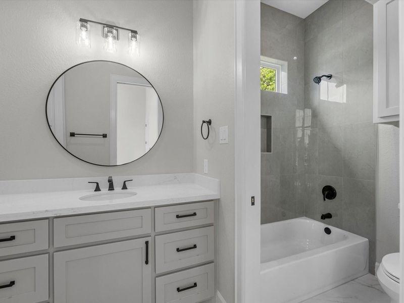 Hollywood bath with a tub and shower combo.