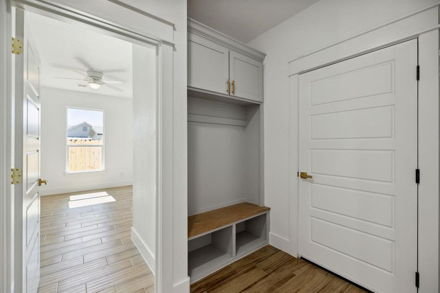 Mudroom with light hardwood / wood-style floors and ceiling fan