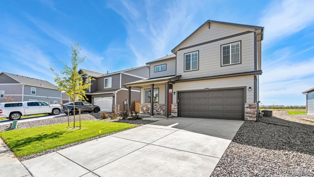 Front exterior of a new home in Hansen Farm, Fort Collins, CO, highlighting curb appeal (Image 2). Front exterior of a new home in Hansen Farm, Fort Collins, CO, highlighting curb appeal (Image 2).