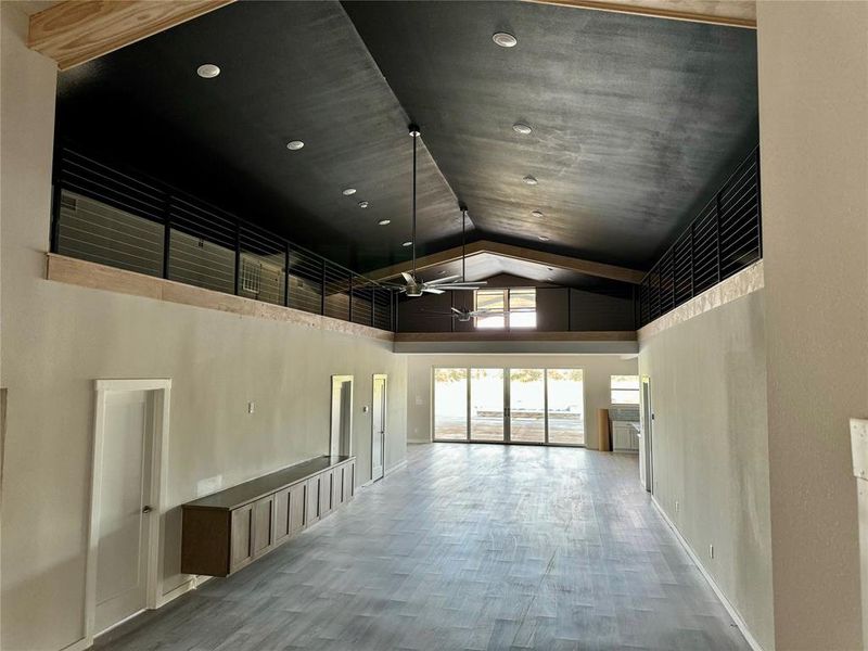 Hall featuring high vaulted ceiling