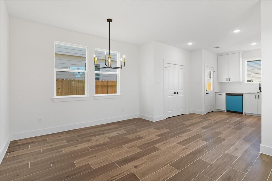 The dining area is bright and welcoming, featuring large windows that bring in abundant natural light. A modern chandelier creates a striking focal point, while the open layout connects seamlessly to the kitchen for easy entertaining. This space combines style and practicality for both everyday meals and special occasions! The dining area is bright and welcoming, featuring large windows that bring in abundant natural light. A modern chandelier creates a striking focal point, while the open layout connects seamlessly to the kitchen for easy entertaining. This space combines style and practicality for both everyday meals and special occasions!