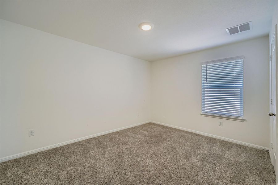 Carpeted empty room featuring baseboards