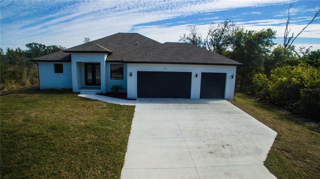 Front exterior of a new home in , Port Charlotte, FL, highlighting curb appeal (Image 1).
