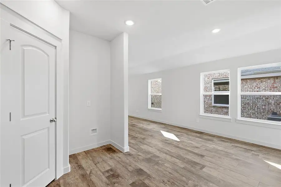 Empty room with light wood-type flooring and recessed lighting Empty room with light wood-type flooring and recessed lighting