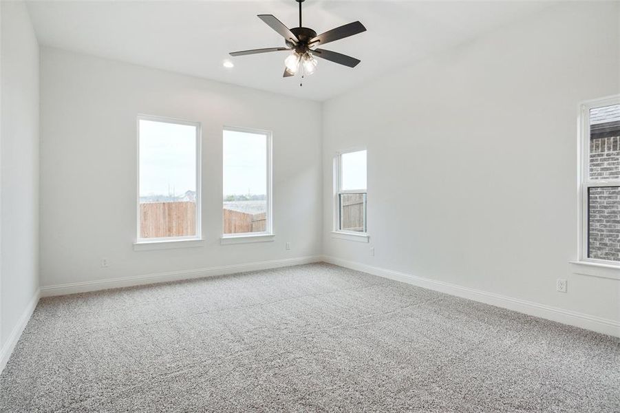 Spare room featuring carpet flooring, ceiling fan, and recessed lighting