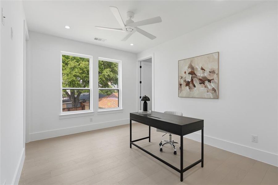 Room featuring two large windows, wood-finish flooring, recessed lighting, a ceiling fan, and white baseboards