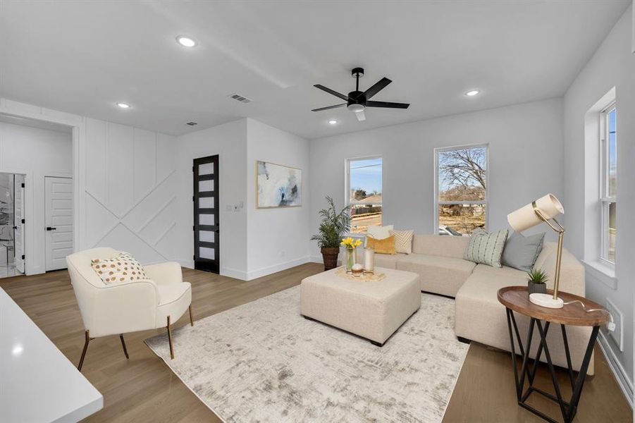 Living room featuring dark wood-type flooring and ceiling fan