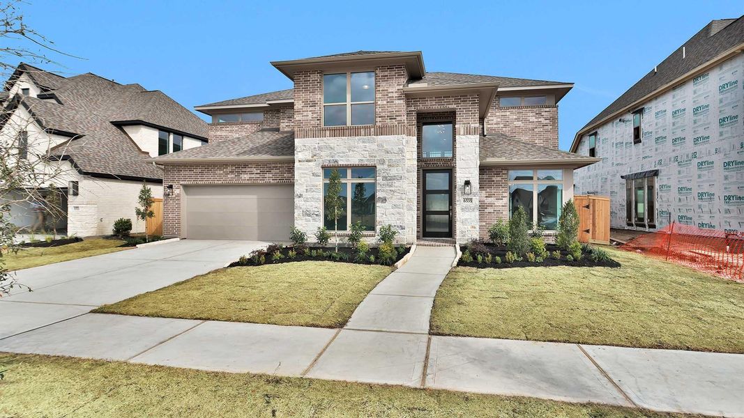 Front exterior of a new home in Valencia, Manvel, TX, highlighting curb appeal (Image 2).