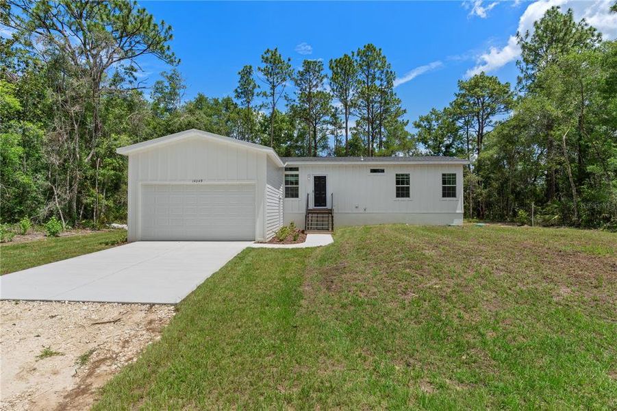Front exterior of a new home in , Weeki Wachee, FL, highlighting curb appeal (Image 21). Front exterior of a new home in , Weeki Wachee, FL, highlighting curb appeal (Image 21).