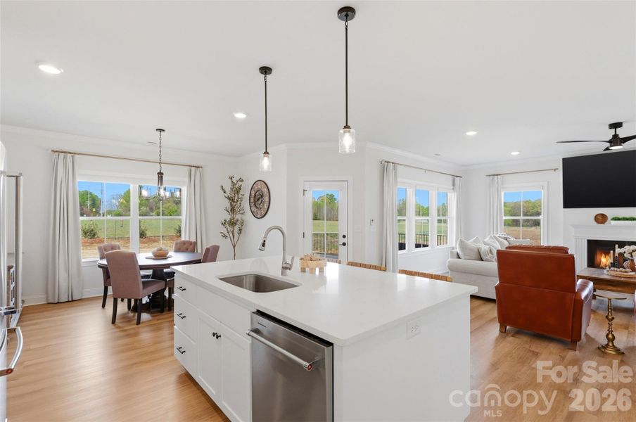 Expansive island anchors the space, offering the perfect spot for gathering and casual dining.