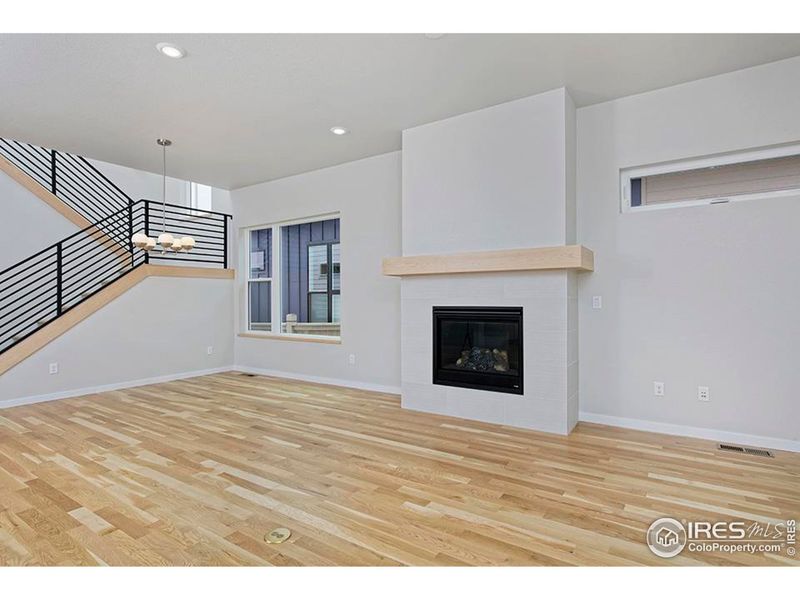 Fluid main level floorplan with gas fireplace and metal railing.