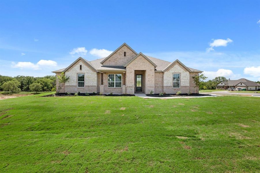 Front exterior of a new home in Saddleback Estates, Boyd, TX, highlighting curb appeal (Image 17). Front exterior of a new home in Saddleback Estates, Boyd, TX, highlighting curb appeal (Image 17).