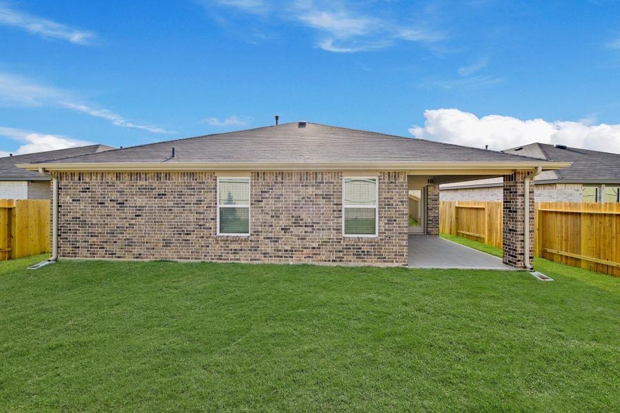 Exterior details and patio area of a home in Harrington Trails at The Canopies, Splendora (Image 16).