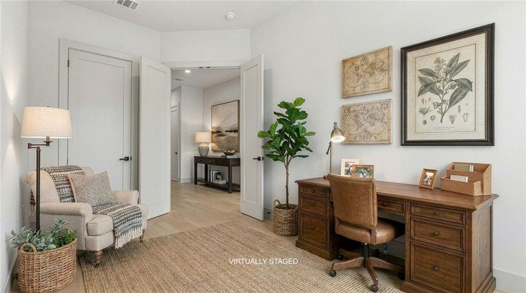 Bright interior space featuring light wood-finish flooring, white walls, and white trim. This could be the office or a 5th bedroom. Located on the first level. Bright interior space featuring light wood-finish flooring, white walls, and white trim. This could be the office or a 5th bedroom. Located on the first level.