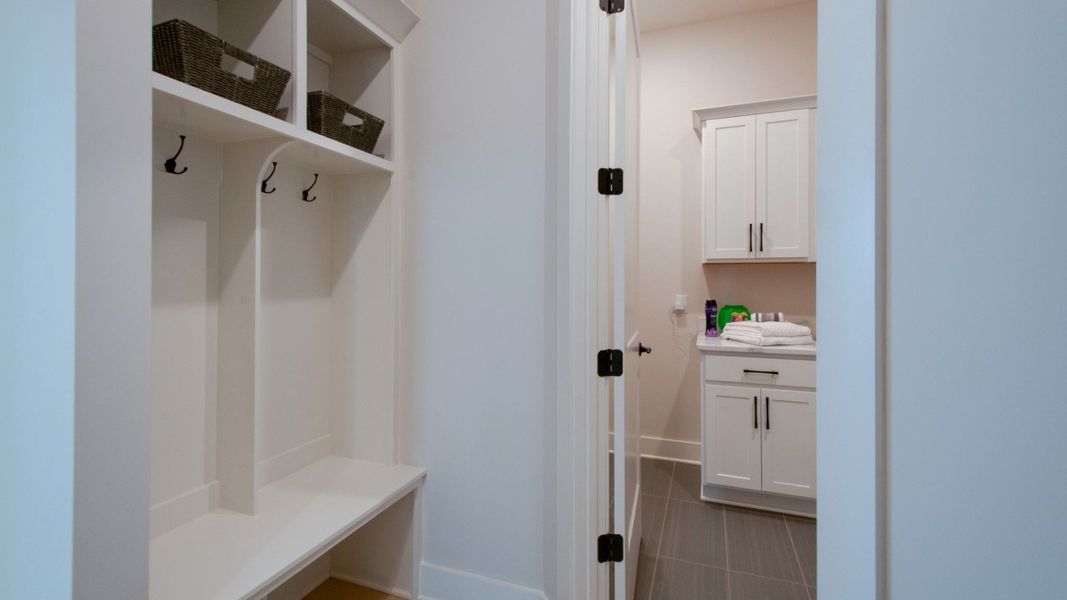 Built in shelving drop zone with entry to laundry room Built in shelving drop zone with entry to laundry room