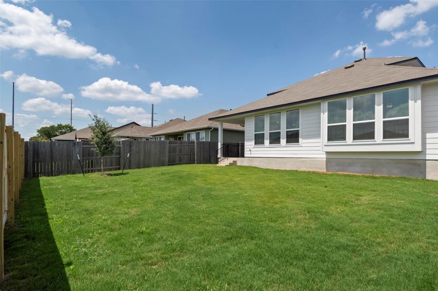 Front exterior of a new home in Orchard Ridge, Liberty Hill, TX, highlighting curb appeal (Image 16). Front exterior of a new home in Orchard Ridge, Liberty Hill, TX, highlighting curb appeal (Image 16).