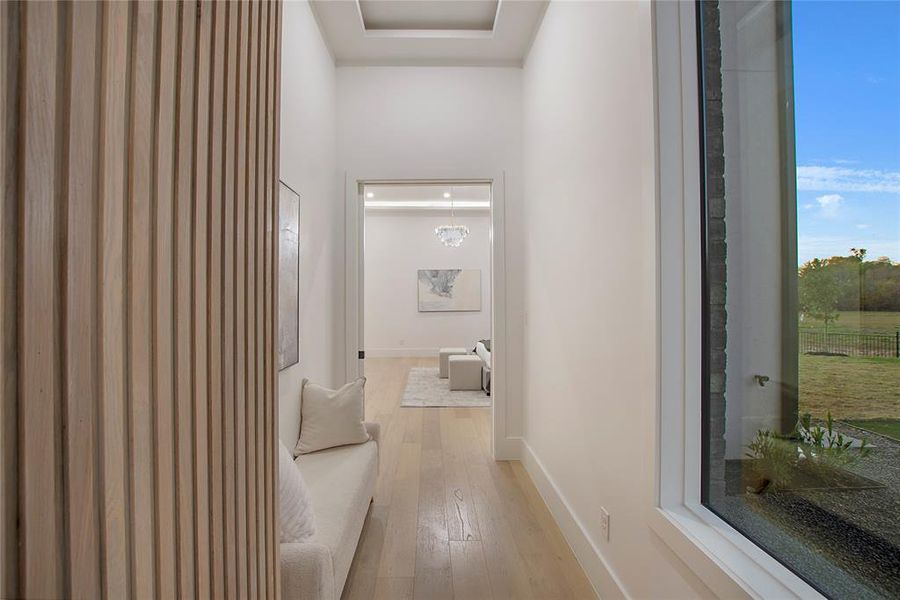 Hallway featuring a chandelier and light hardwood / wood-style floors