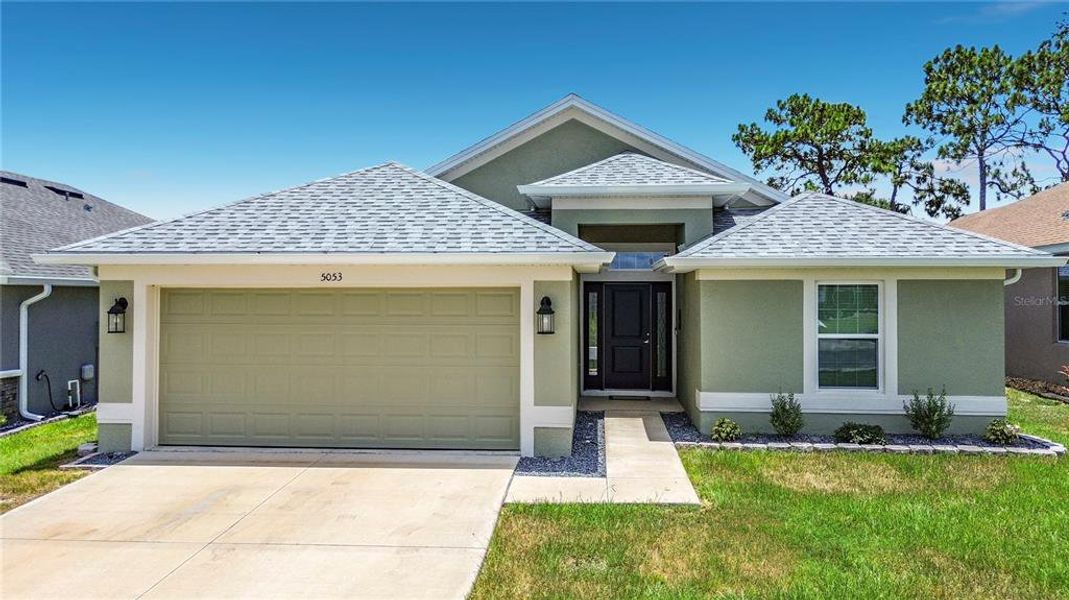 Front exterior of a new home in Twisted Oaks, Beverly Hills, FL, highlighting curb appeal (Image 2). Front exterior of a new home in Twisted Oaks, Beverly Hills, FL, highlighting curb appeal (Image 2).