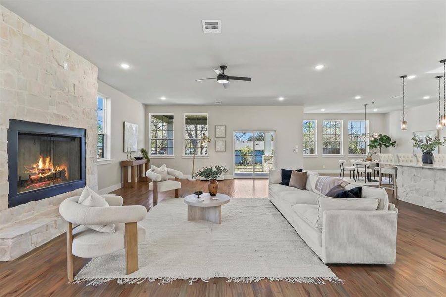 Living area with dark wood-style flooring, a fireplace, recessed lighting, and ceiling fan Living area with dark wood-style flooring, a fireplace, recessed lighting, and ceiling fan