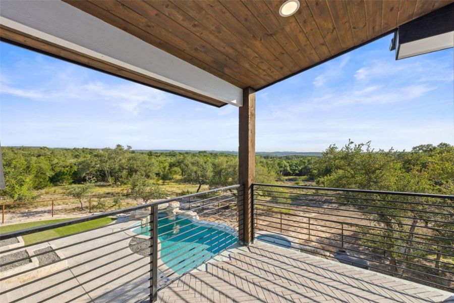 An inviting private patio presents a refreshing pool with an expansive, verdant landscape beyond. An inviting private patio presents a refreshing pool with an expansive, verdant landscape beyond.
