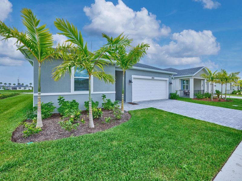 Front exterior of a new home in Azalea, Port St. Lucie, FL, highlighting curb appeal (Image 26).