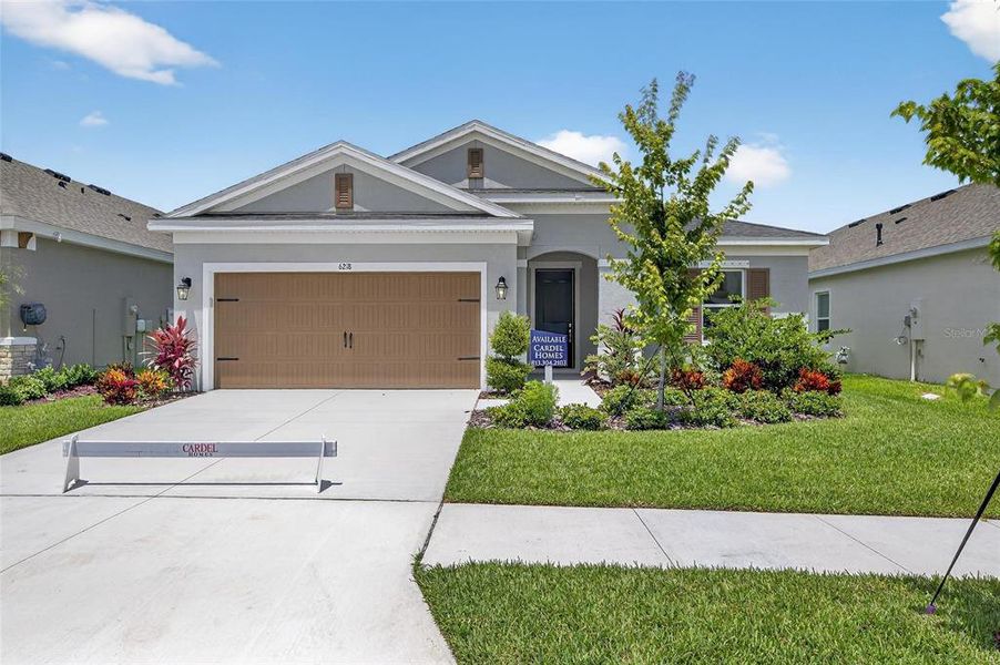 Front exterior of a new home in Waterset, Apollo Beach, FL, highlighting curb appeal (Image 1).