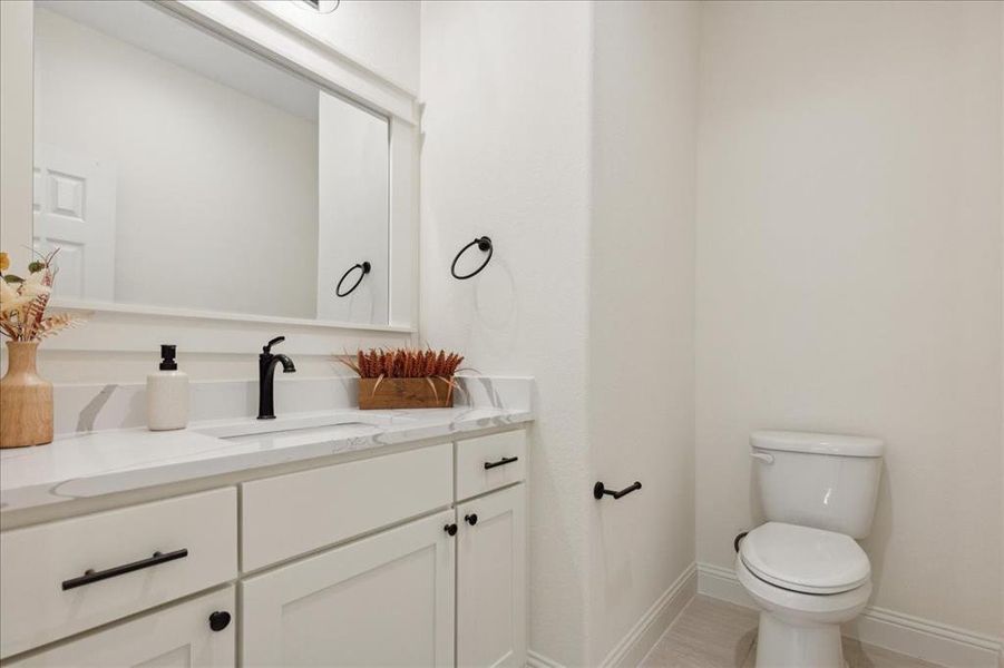 Bathroom with vanity, toilet, and hardwood / wood-style floors