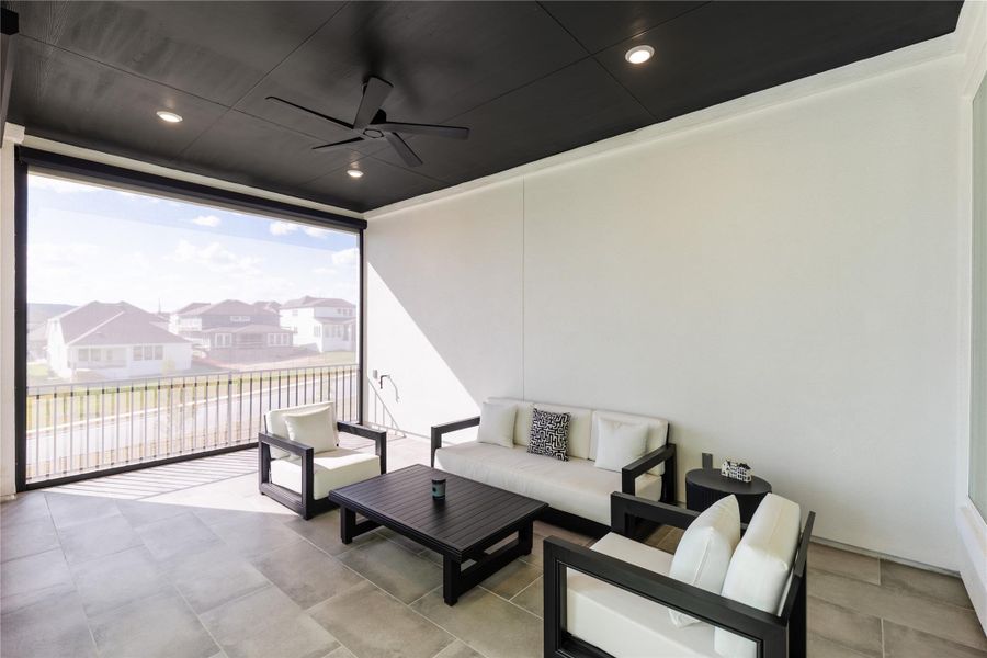 View of patio featuring a ceiling fan, an outdoor living space, and a residential view
