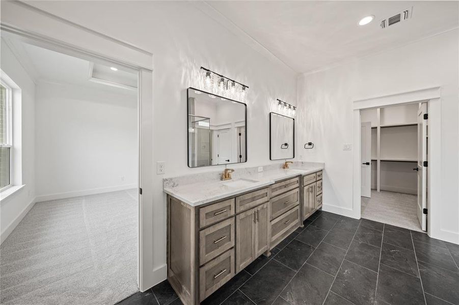 Dual vanity with light-toned cabinetry and light-colored countertops